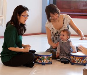 Teacher with child on drums=